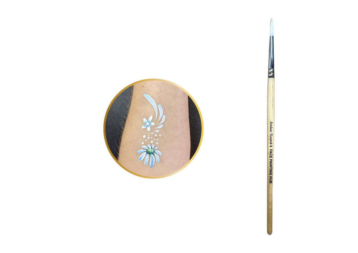 A fine-detail nail art brush with a light wood handle and silver ferrule, shown next to a circular inset demonstrating a light blue floral design painted on skin.